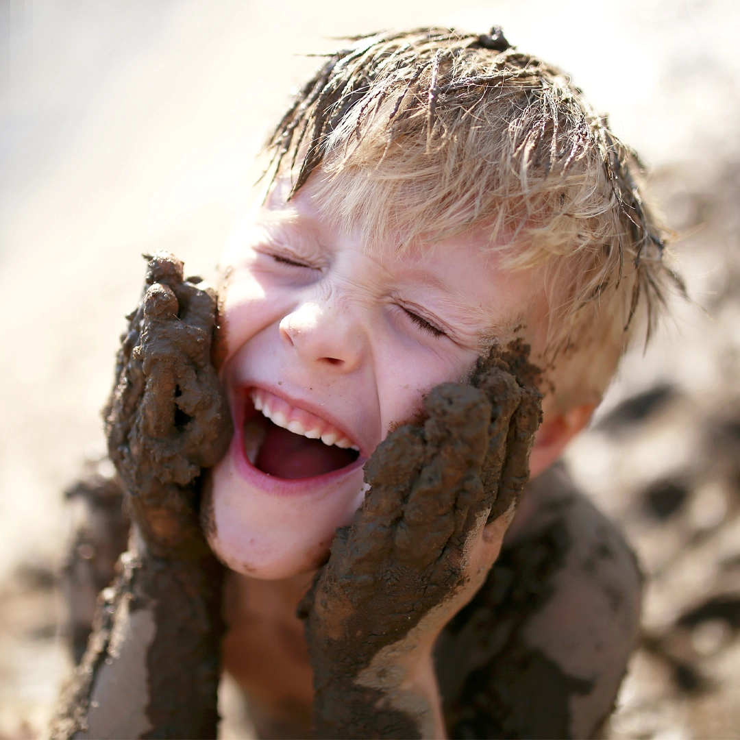 Happy boy with muddy hands