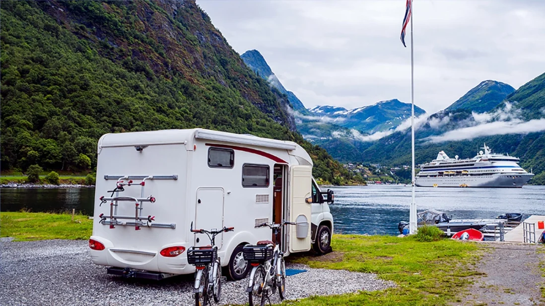 RV on beach with cruise ship in background