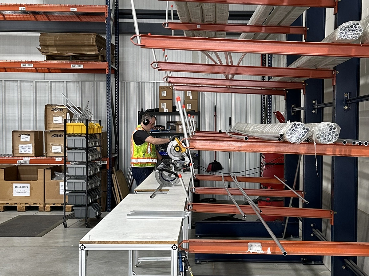 Alde assembly employee cutting pipes at Truma North America